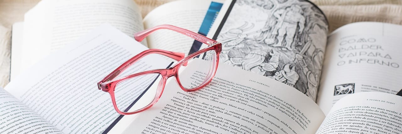 An open book with reading glasses