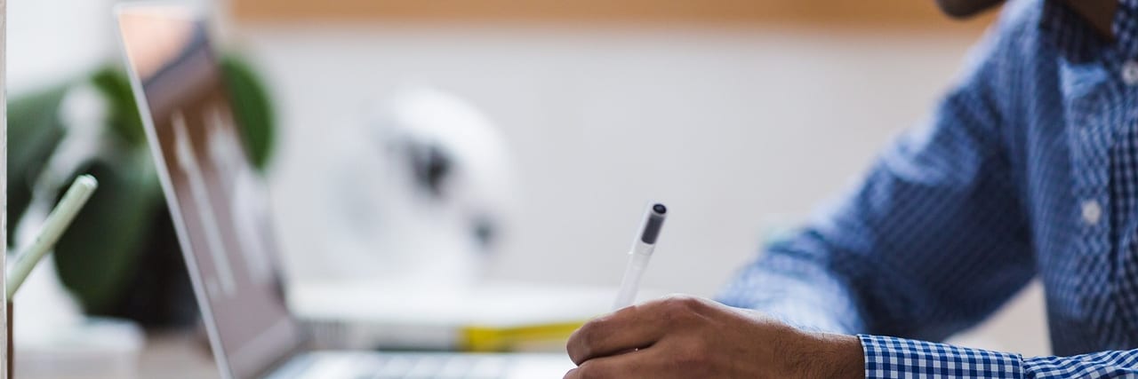 A student studying at a desk with notes