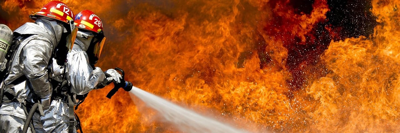 A red fire extinguisher mounted on a wall