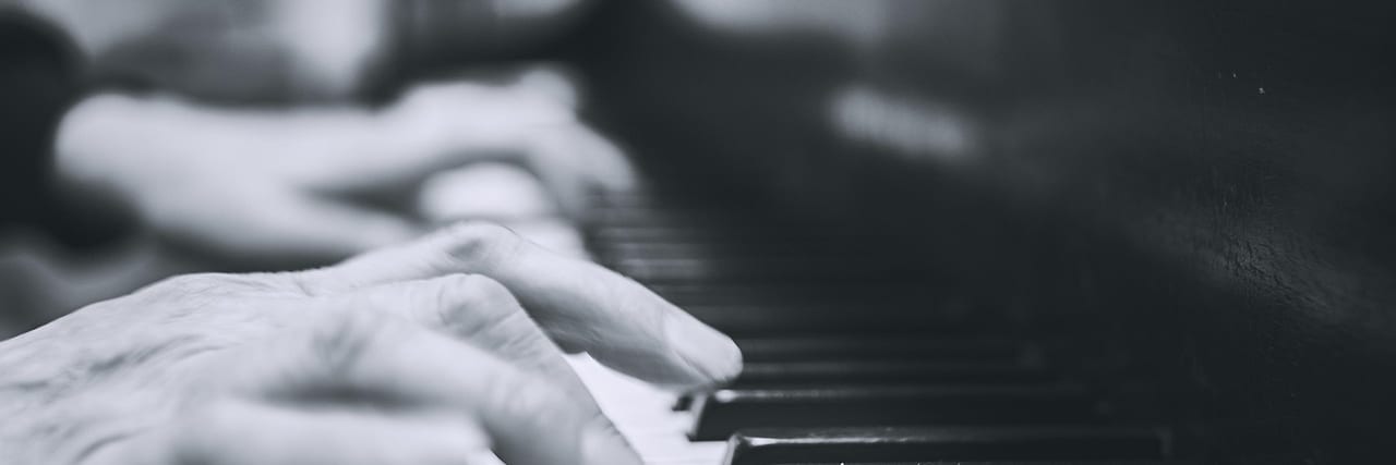 Hands playing a sequence on piano keys