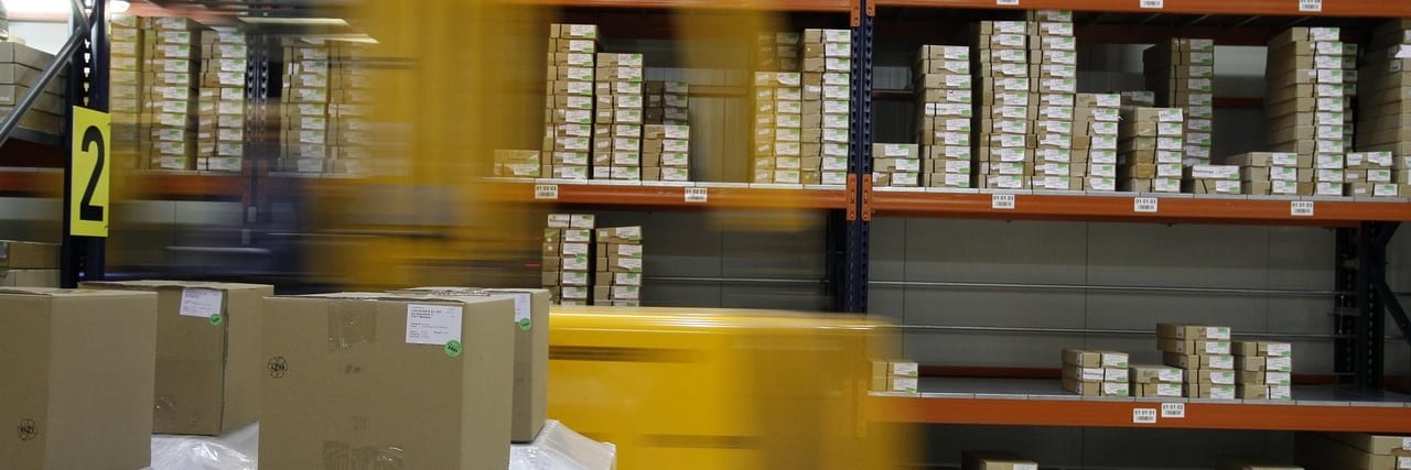 A warehouse worker lifting a box